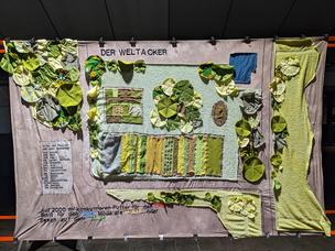 Der Weltacker als Kunstwerk aus Alttextilien: mit verschiedenen Näh- und Sticktechniken wurde der Weltacker auf ein Bettlaken gezaubert